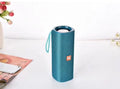 Cloth-covered portable Bluetooth speaker in multiple colours showing USB port and control buttons.