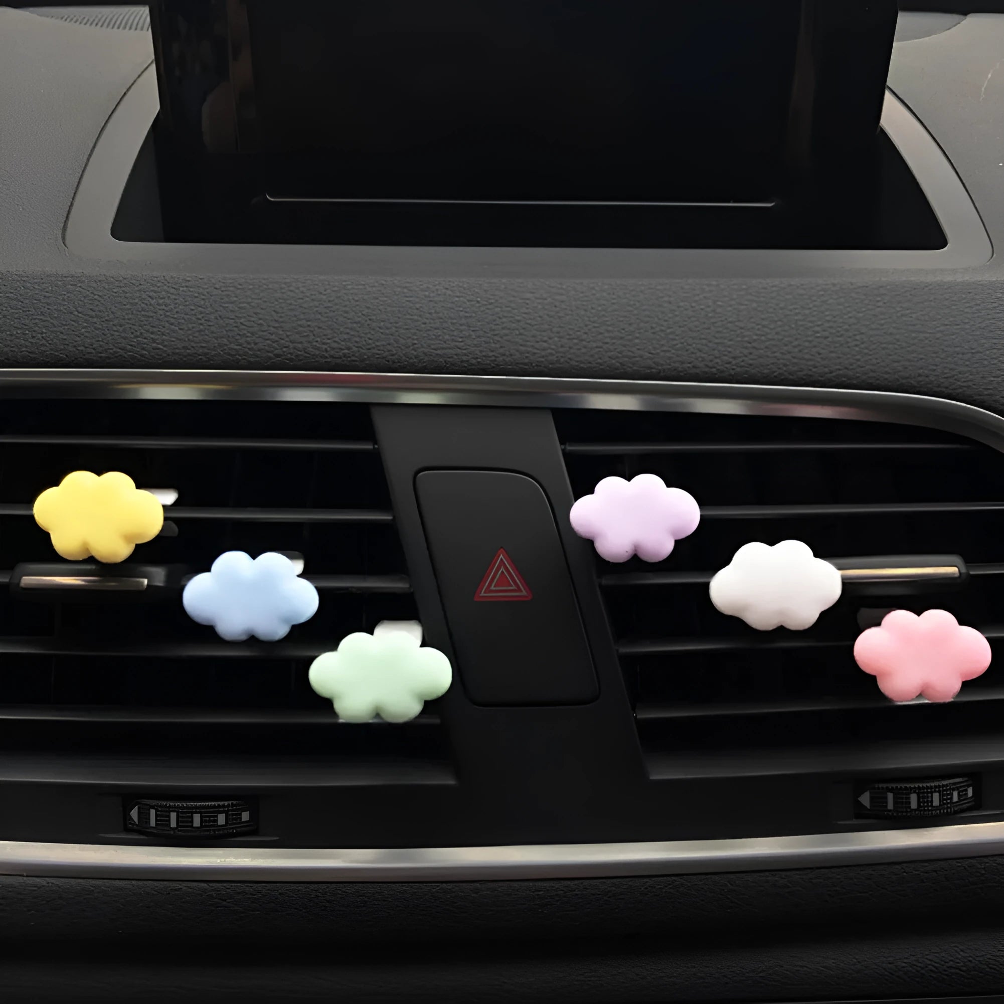 Resin cartoon cloud car air freshener clip in assorted colours on a car vent.