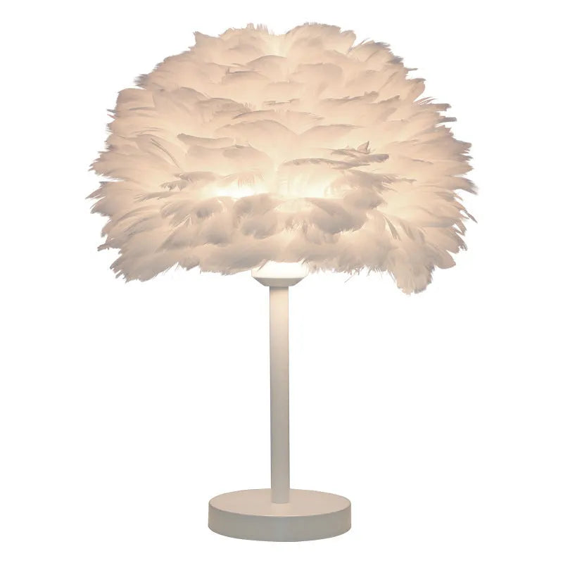 White handmade feather table lamp with metal base on a wooden desk, remote control visible, 30cm diameter