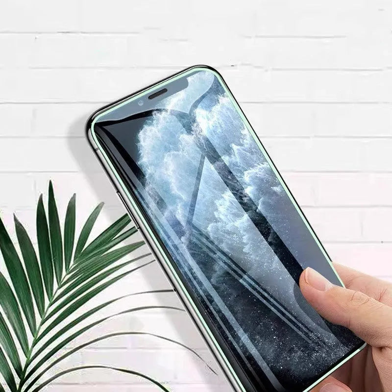 Luminous full cover tempered glass screen protector for iPhone glowing blue in the dark.