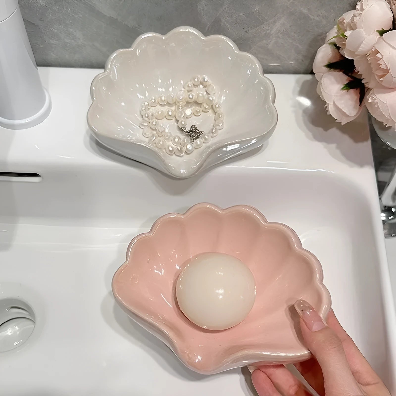 White and pink plastic shell-shaped soap dish for bathroom counter or shower