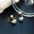 Heart-shaped stud earrings with pearlescent artificial gemstone accents on electroplated alloy