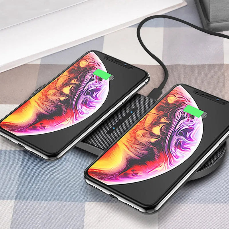 A pair of black 10W dual wireless charging stands on a desk.