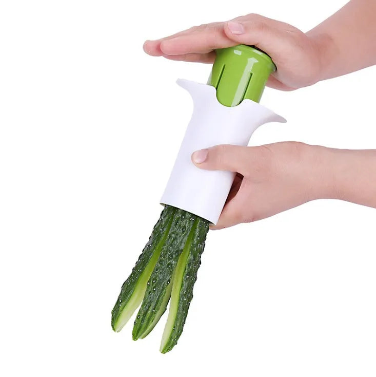White kitchen slicer with six stainless steel blades for cutting cucumbers, carrots, and strawberries.