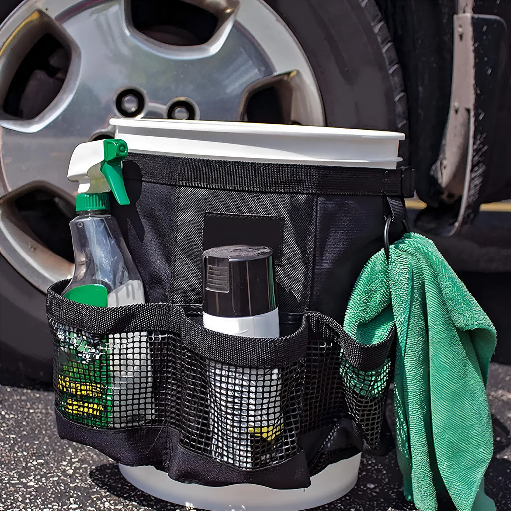 Black cylindrical polyester storage bag hanging on a 5 gallon barrel for organising tools.