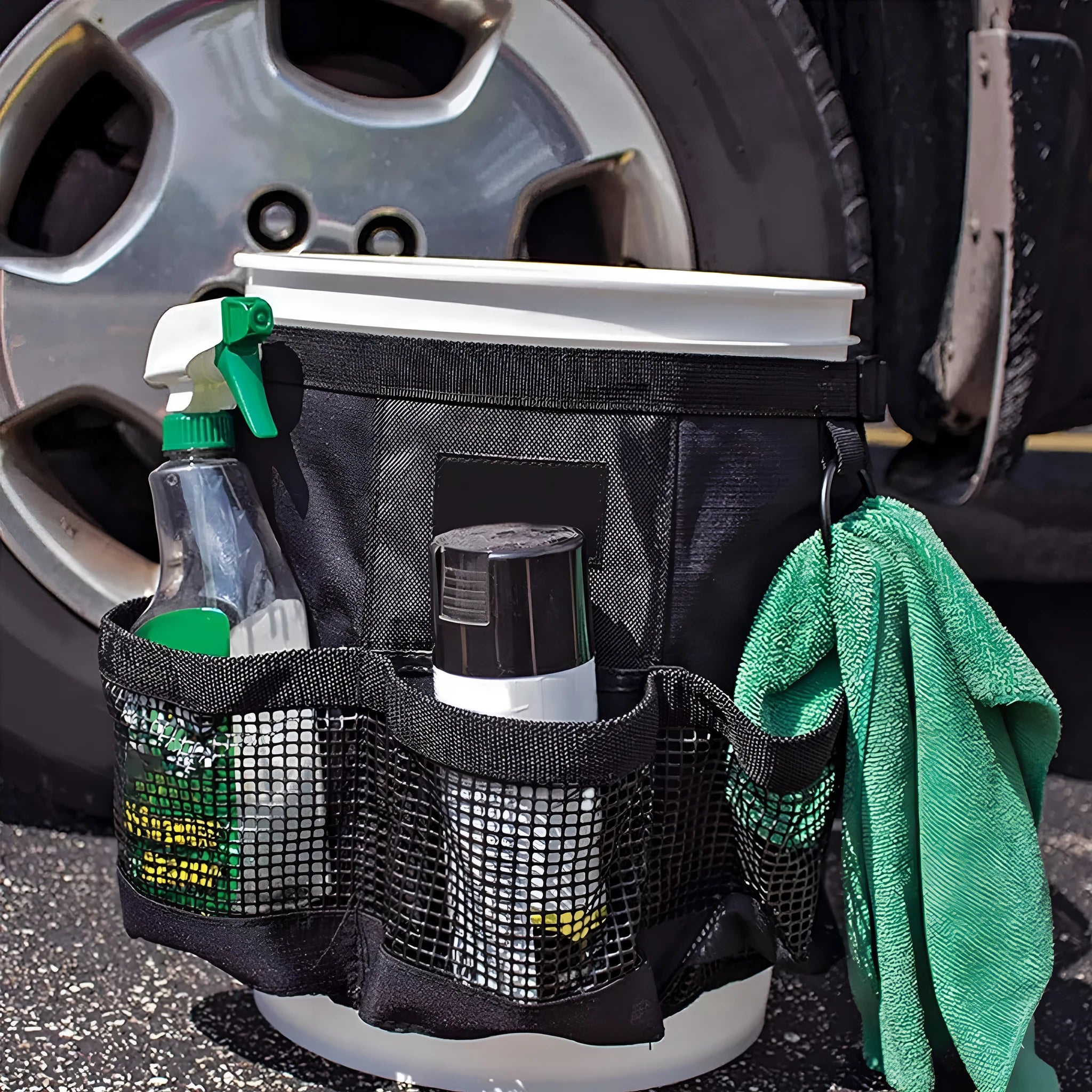 Black cylindrical polyester storage bag hanging on a 5 gallon barrel for organising tools.