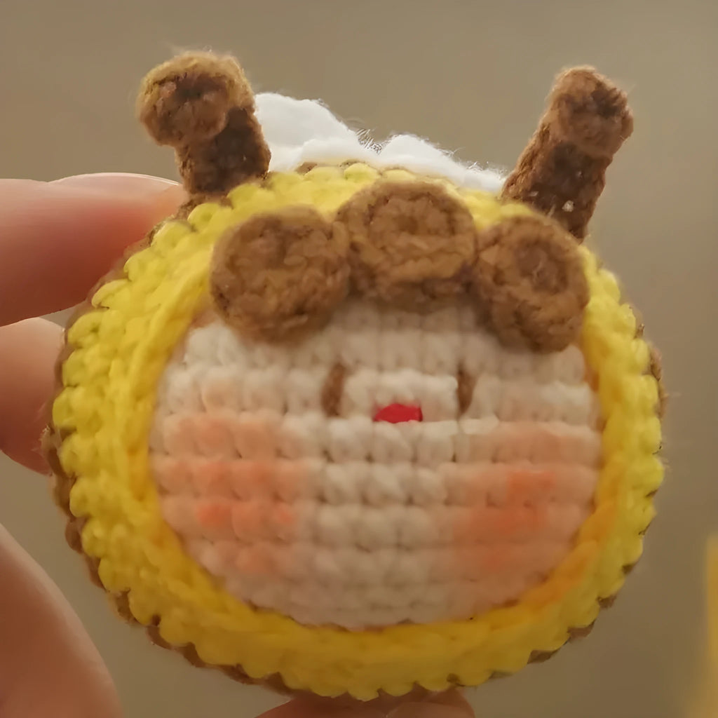 Handmade crocheted bee colony pendant accessory for a woolen doll.