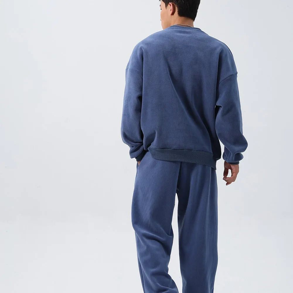 Men's polar fleece sports suit showing long-sleeved top and padded trousers in light grey colour