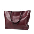 Horizontal brown cowhide leather crossbody handbag showing two main compartments and a front pocket.