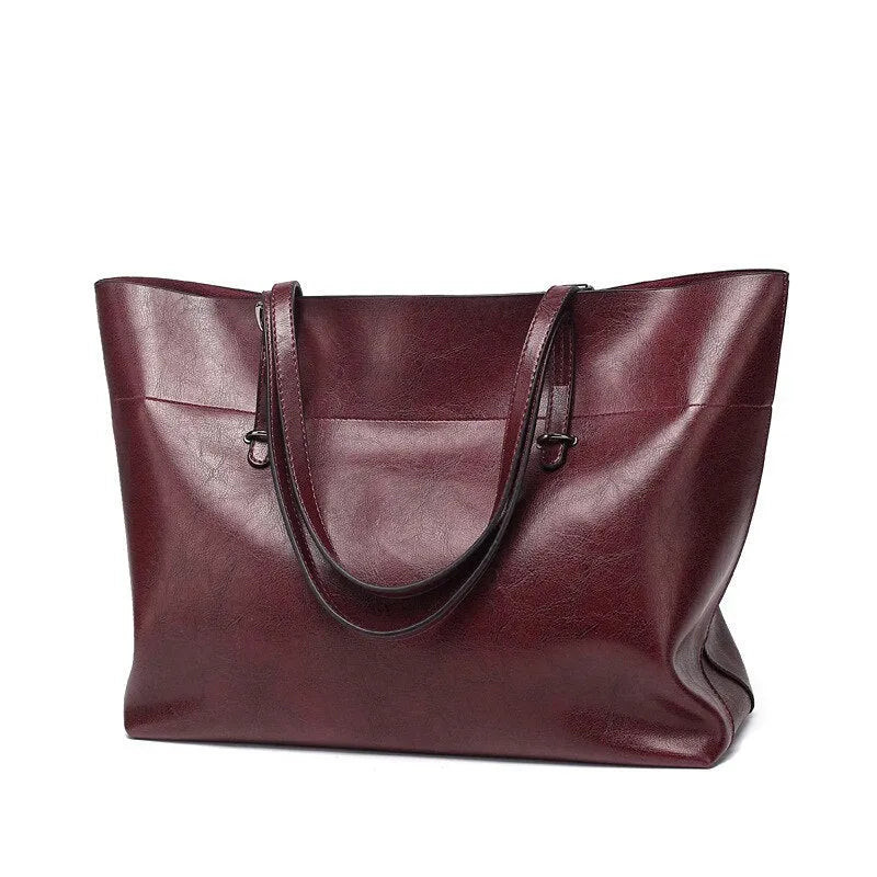 Horizontal brown cowhide leather crossbody handbag showing two main compartments and a front pocket.