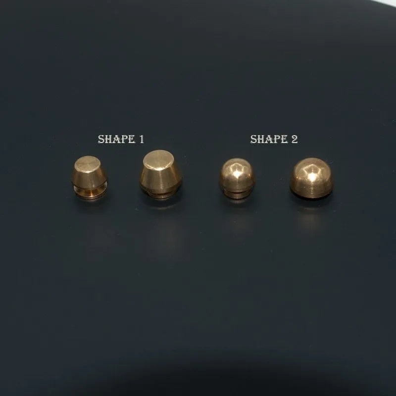Assortment of brass decorative buckles in antique gold finish showing round foot nail and bucket foot nail designs