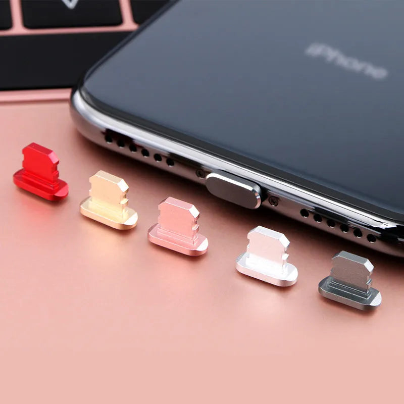 Aluminium alloy mobile phone charging port dust plug for iPhone, shown in multiple colours.