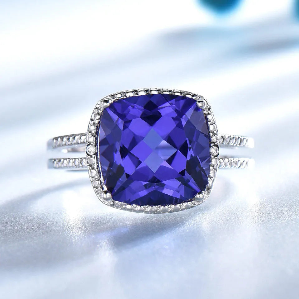 Close-up of a sterling silver ring with a blue tanzanite gemstone.