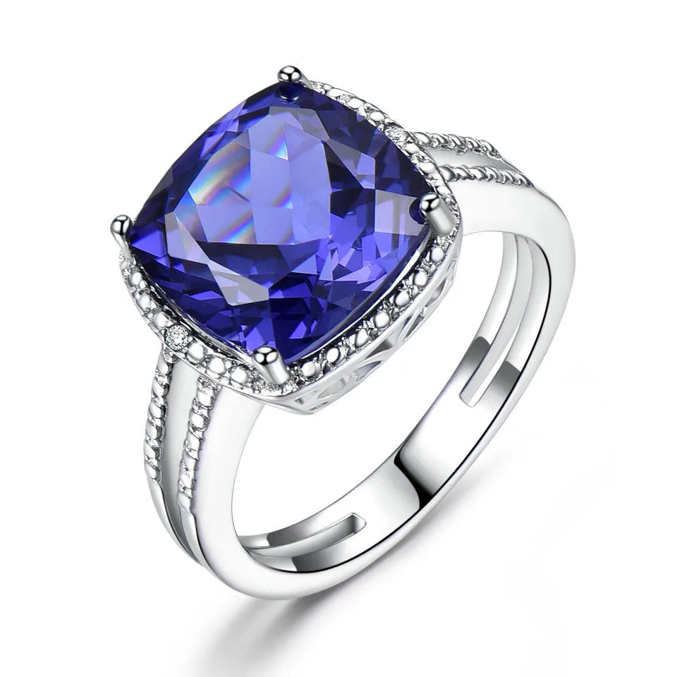 Close-up of a sterling silver ring with a blue tanzanite gemstone.