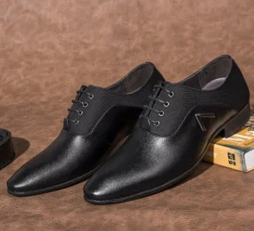 Men's black Oxford-style lace-up shoes with a low upper and rubber sole for business casual wear.