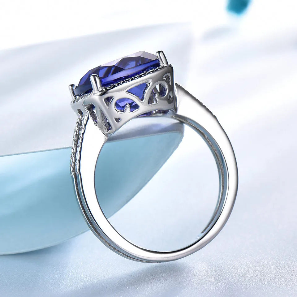 Close-up of a sterling silver ring with a blue tanzanite gemstone.