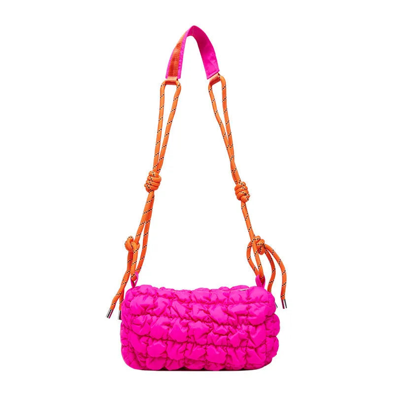 Women's lightweight nylon messenger bag in pillow shape with a crossbody strap, shown in rose red with a rhombus pattern.
