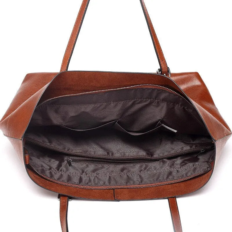 Horizontal brown cowhide leather crossbody handbag showing two main compartments and a front pocket.