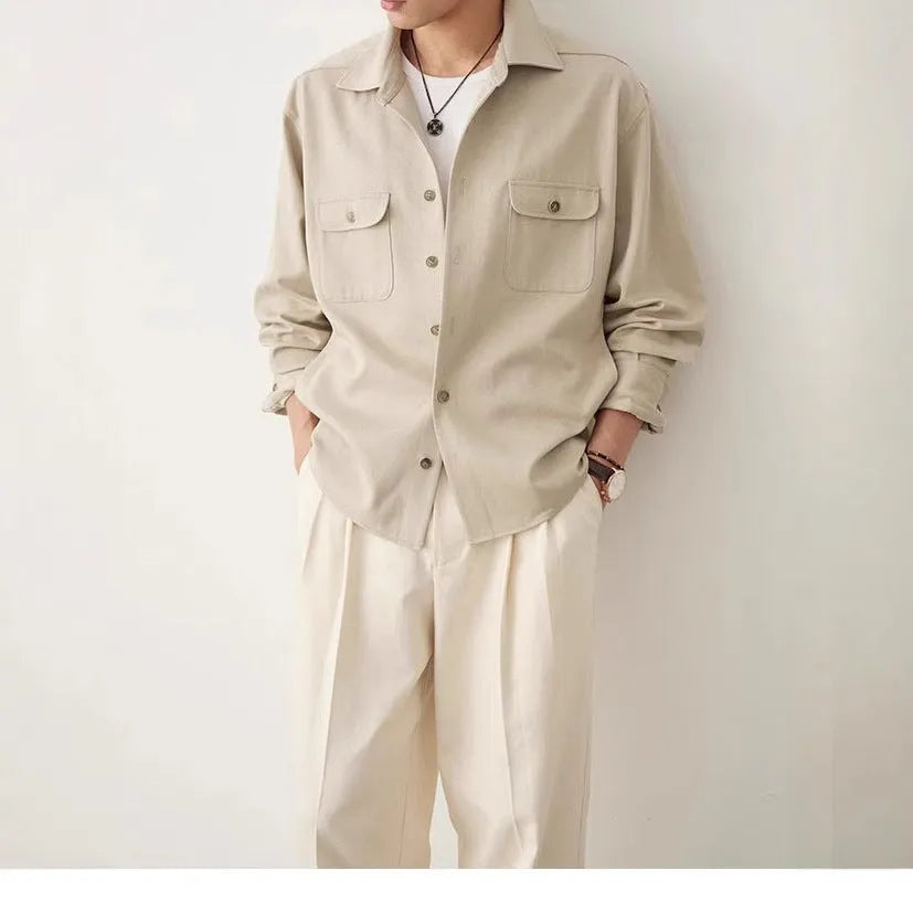 Men's light sand rice coloured long sleeve shirt with a simple lapel collar on a hanger.