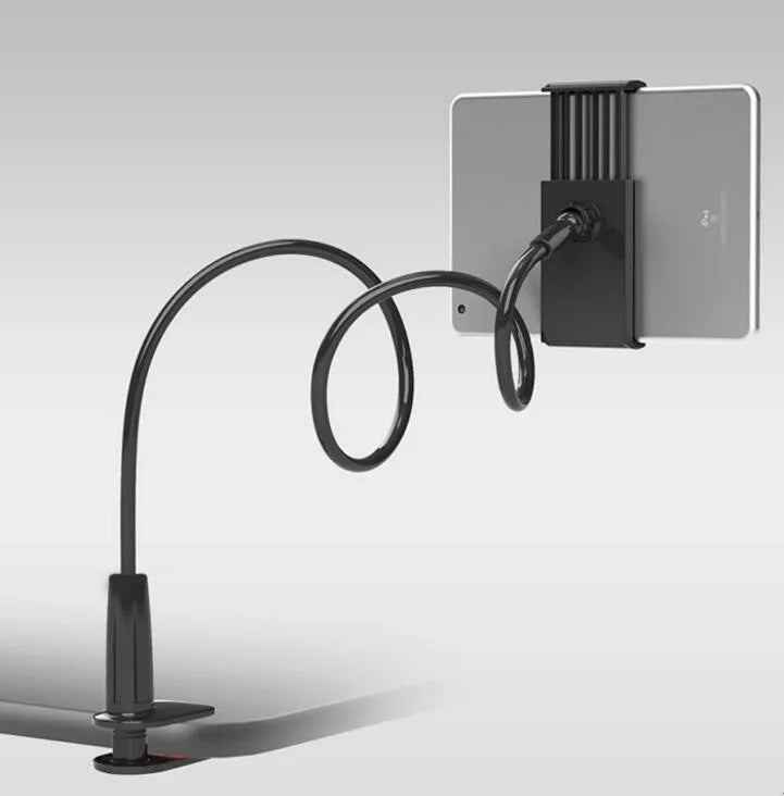 Black bedside phone handset with a long aluminium arm holding a mobile phone on a table.