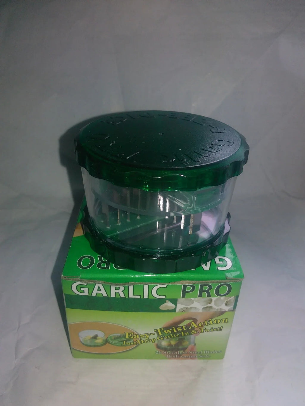 Green transparent polypropylene garlic peeler on a kitchen counter