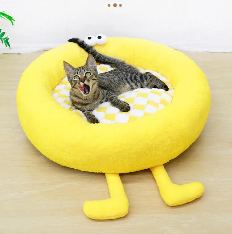 A plush, thick nest-style dog bed for small to medium sized pets, shown in yellow, pink, or black.