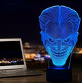 A 3D acrylic LED lamp with a square base, displaying one of its seven colour options on a desk.