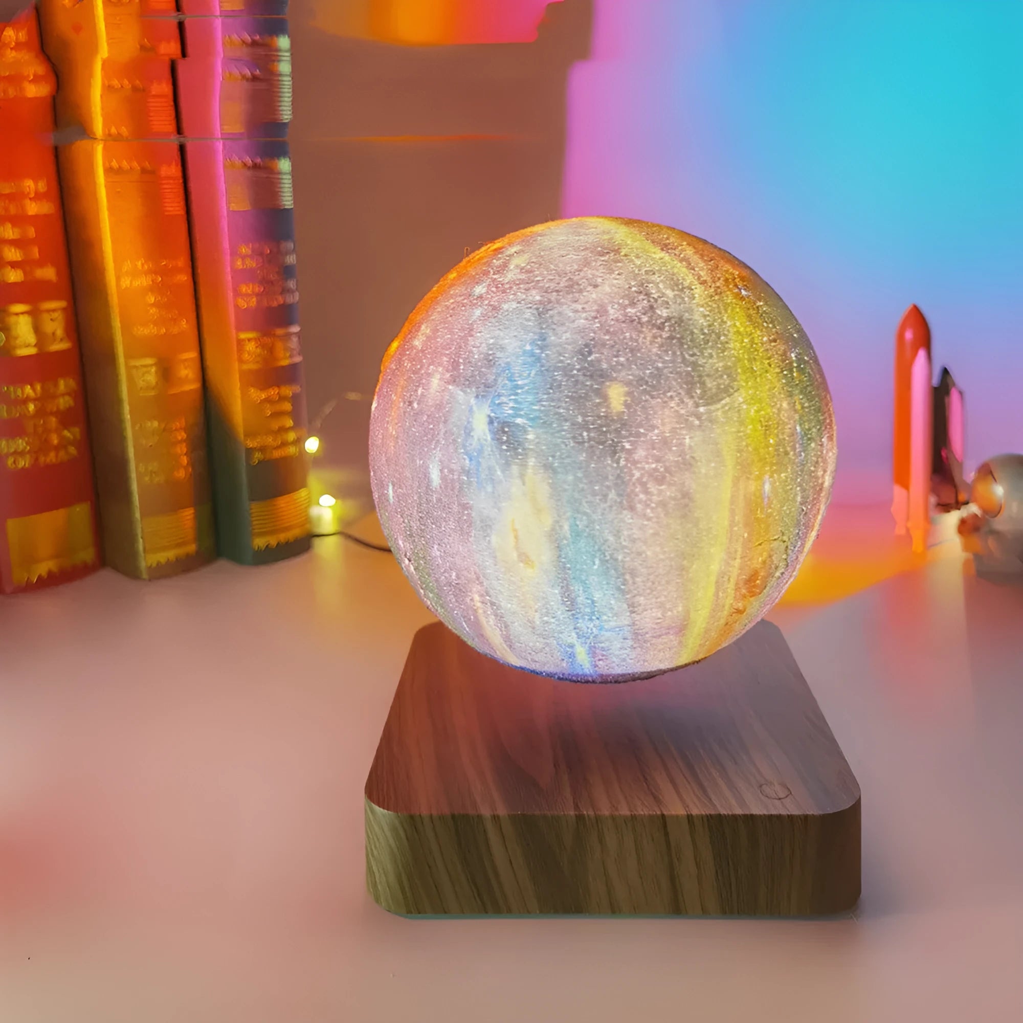 Square walnut coloured levitating moon lamp with galaxy design hovering above a circular base.