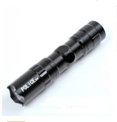 Compact black aluminium LED mini flashlight with keyring, shown next to a AA battery for scale.