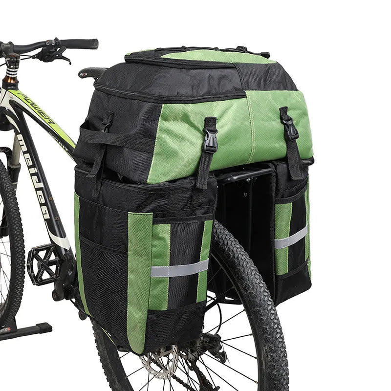 Green bicycle rear storage bag with 70 litre capacity mounted on a bike rack for touring.