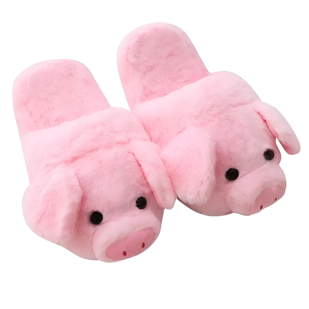 Pink pig-shaped plush floor slippers on a plain background.