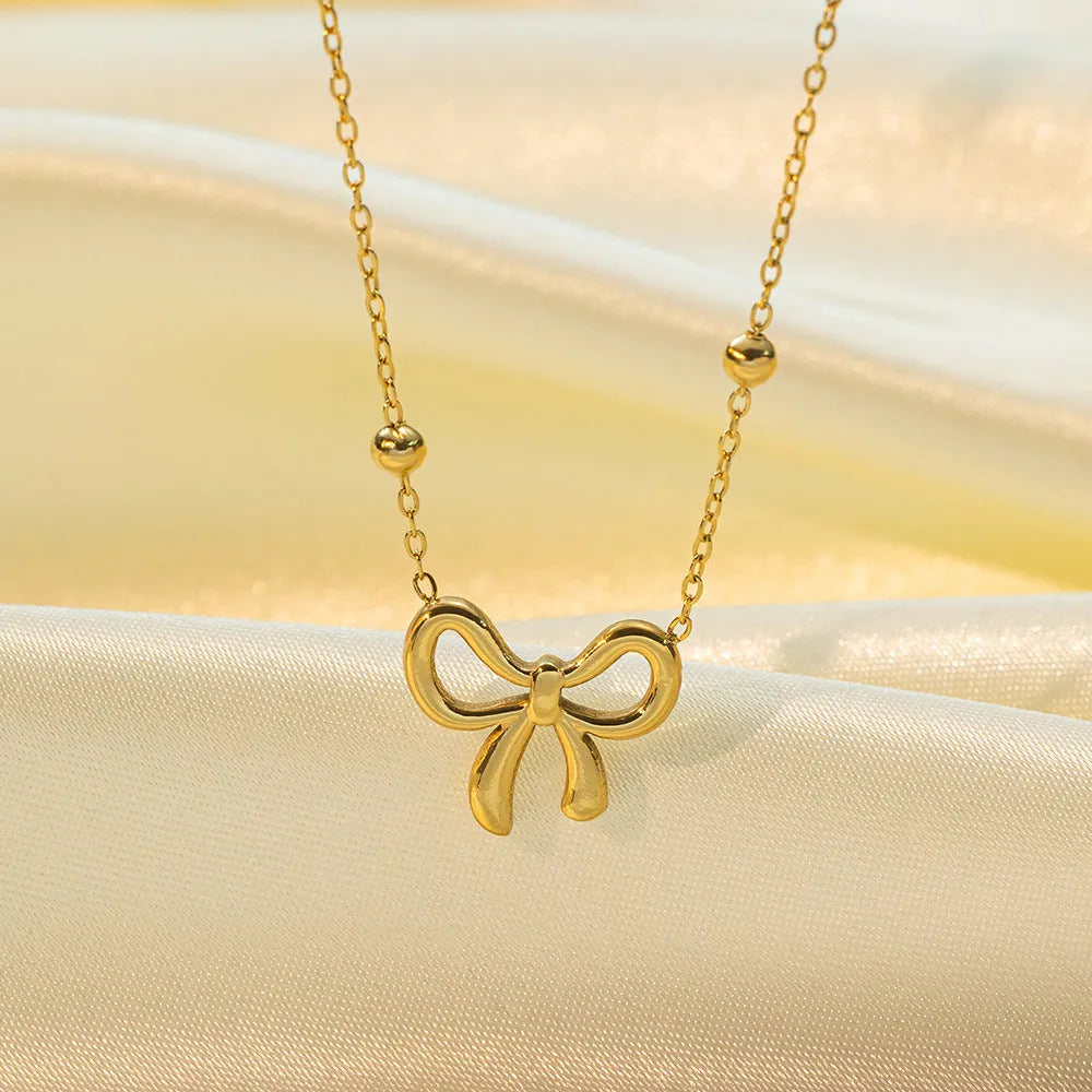 Gold bow necklace on adjustable 41-50cm titanium steel chain with cross link design