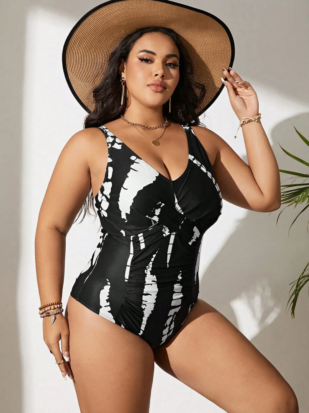 Black conservative one-piece swimsuit on a mannequin, showing sleeveless design and Siamese colour matching pattern.