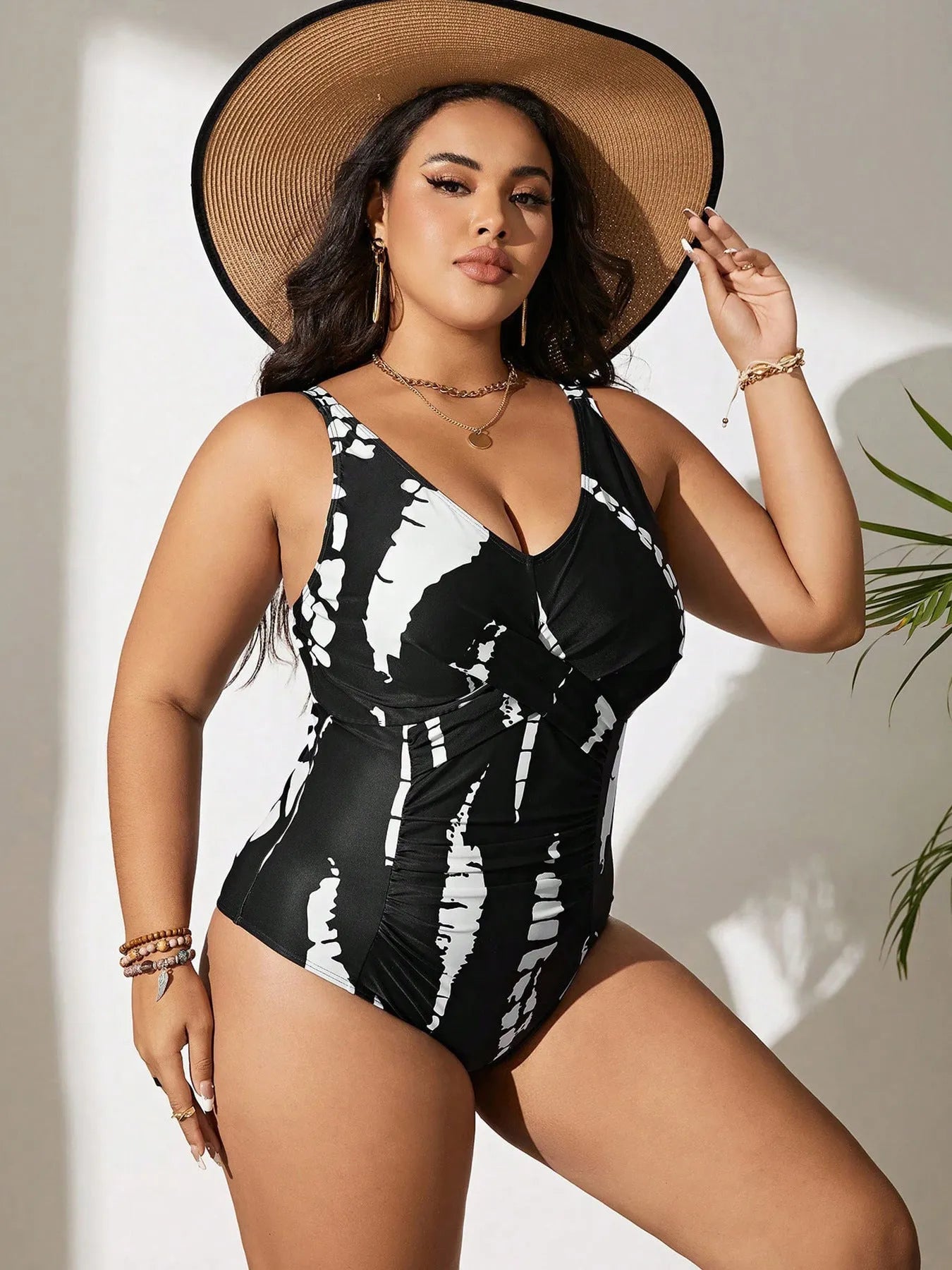 Black conservative one-piece swimsuit on a mannequin, showing sleeveless design and Siamese colour matching pattern.