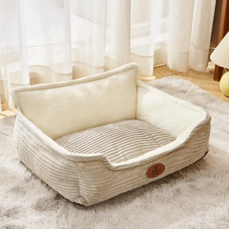 Coffee and white coloured removable washable dog kennel bed shown in small and medium sizes on a sofa and floor.