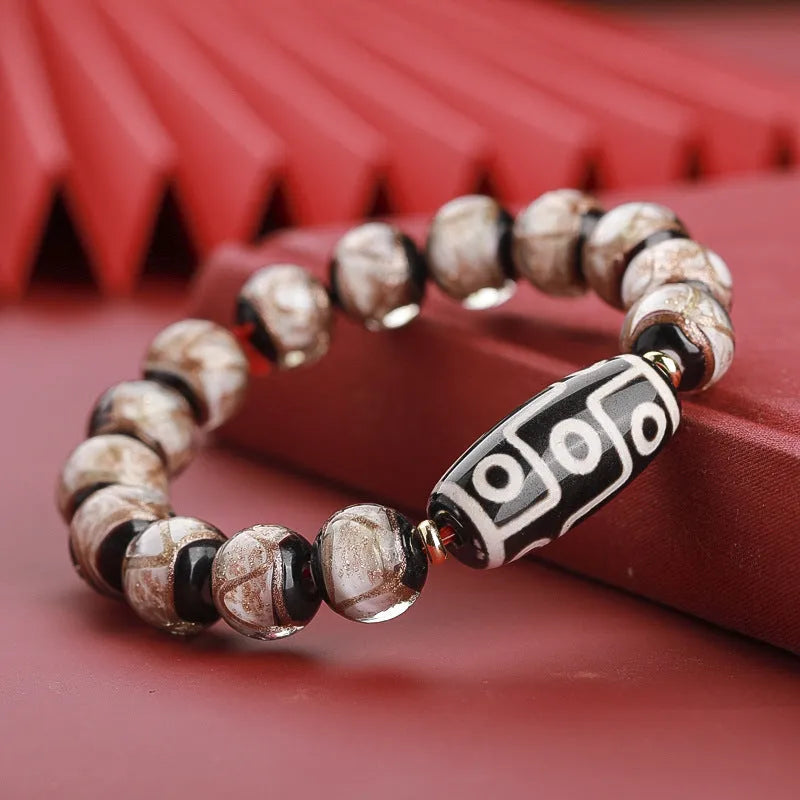 Chinese-style bracelet with coloured glaze beads showing snake and multi-treasure patterns.
