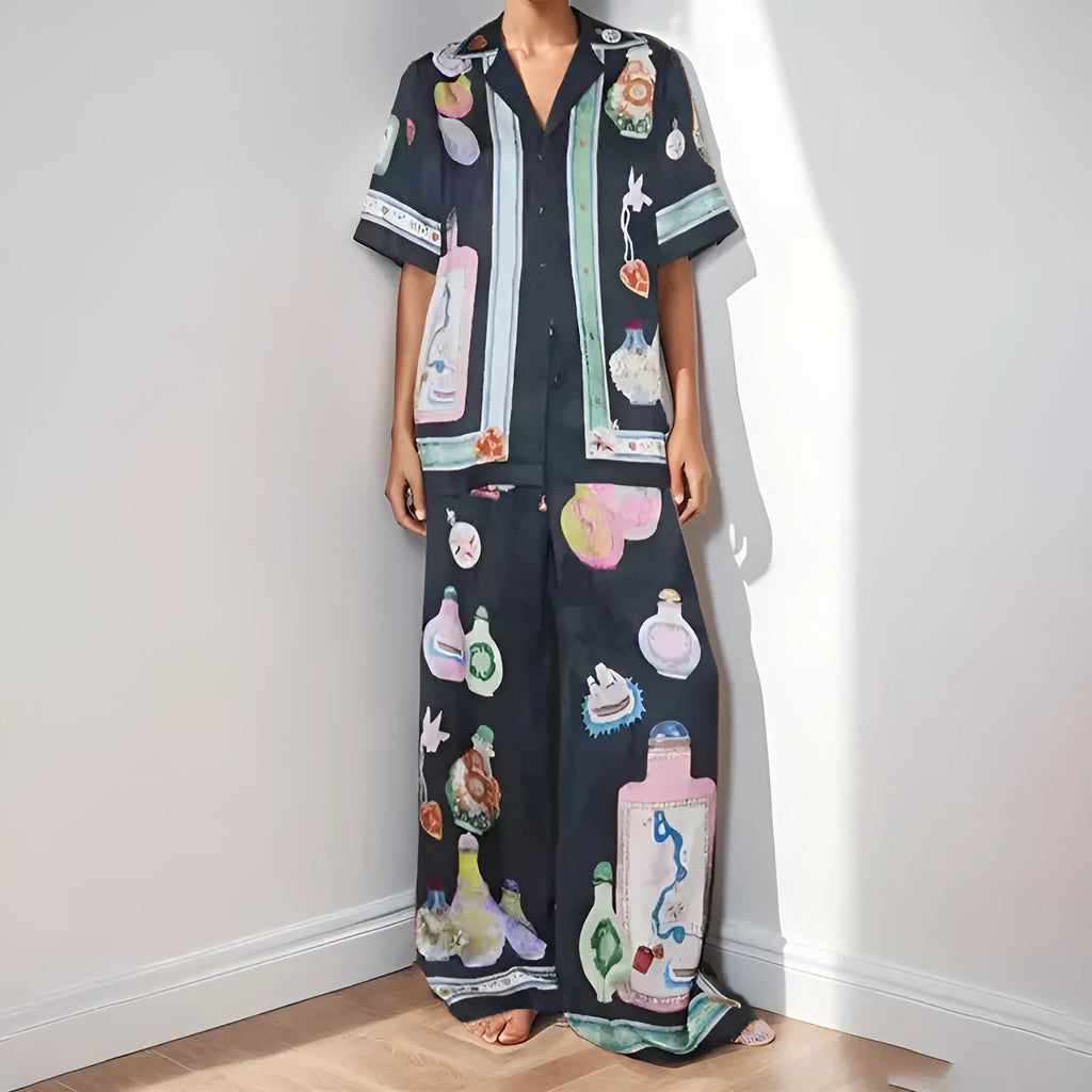 Black women's cardigan and trouser set with cartoon print, showing front view.