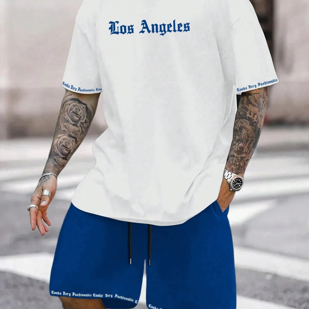 Man wearing a blue printed sports-style short-sleeve top and matching shorts set.