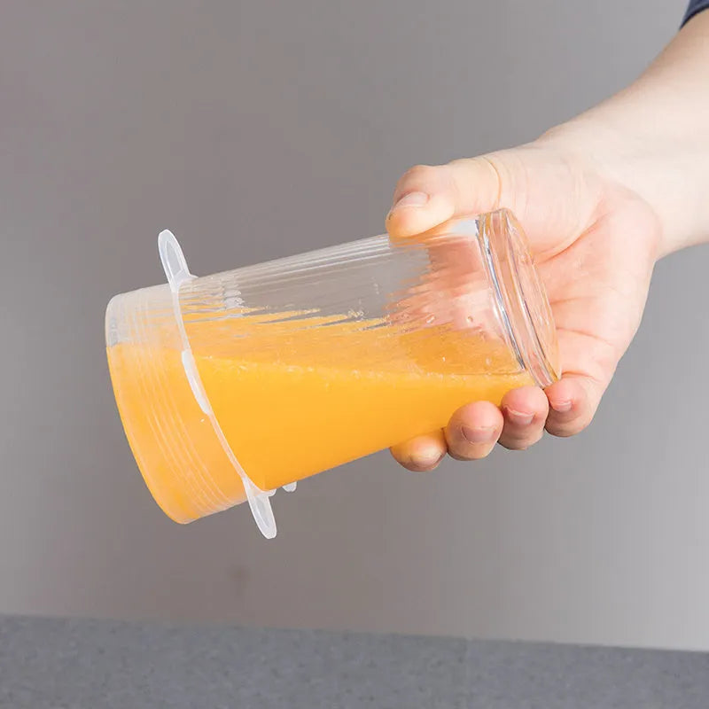 Set of six colourful silicone stretch lids in different sizes arranged on a kitchen counter.