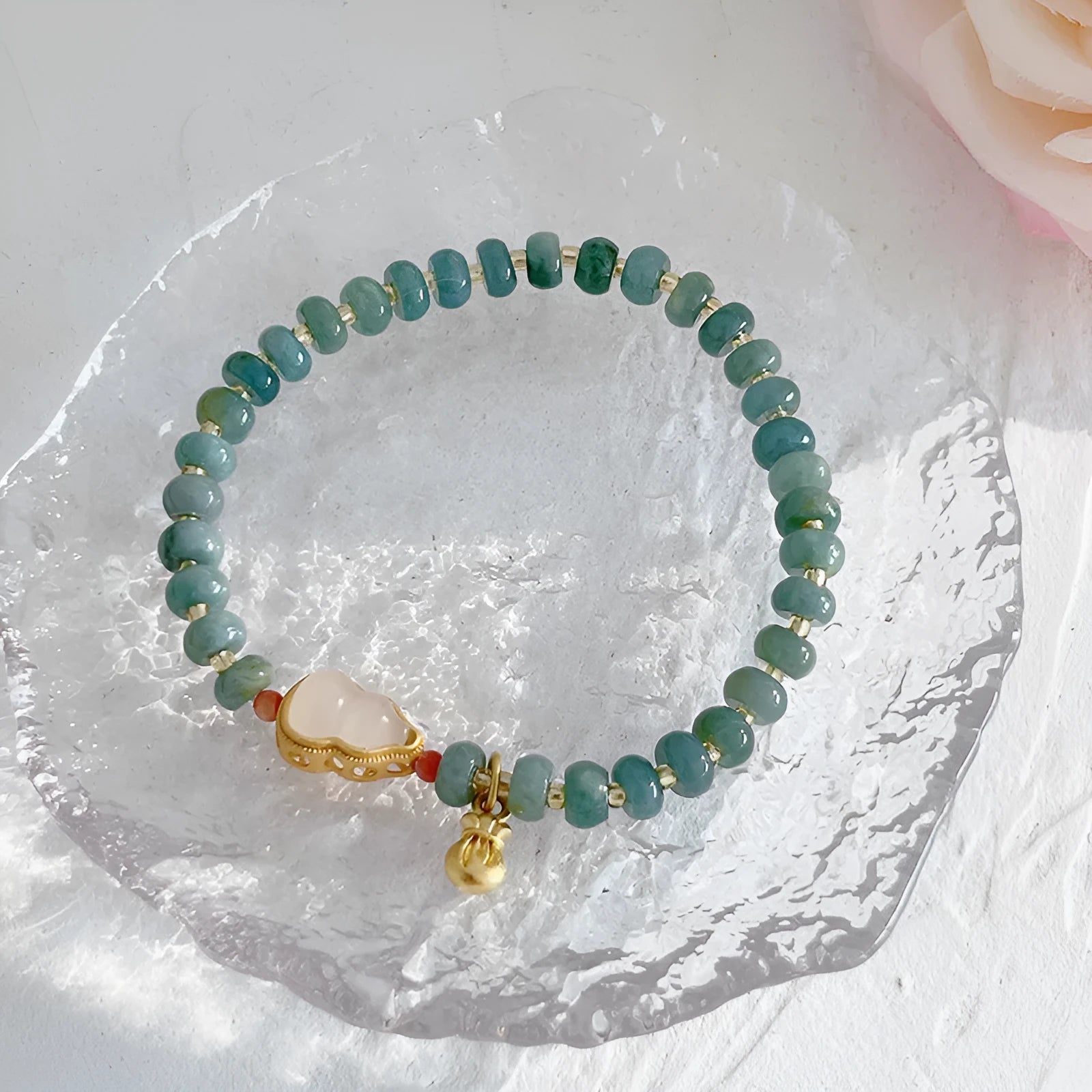 Natural blue water jade bracelet with gourd charm and peace buckle on woman's wrist
