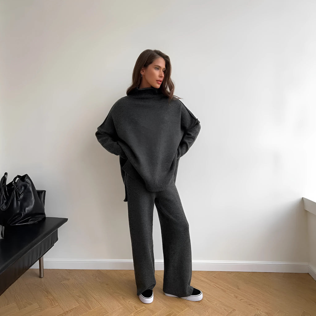 Women's knitted two-piece suit with side-slit sleeve jumper and trousers in dark grey.