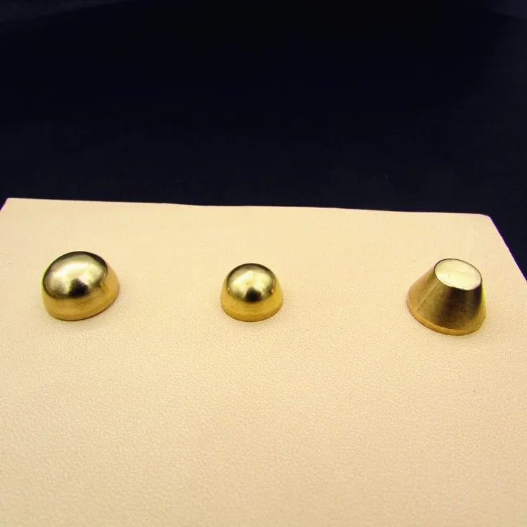 Assortment of brass decorative buckles in antique gold finish showing round foot nail and bucket foot nail designs