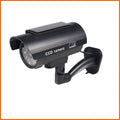Black gun-style solar simulation security camera for indoor and outdoor deterrent use
