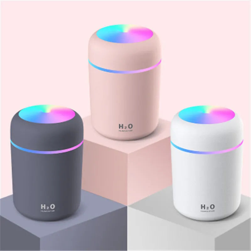 Pink car USB humidifier with LED lights showing water tank and control button