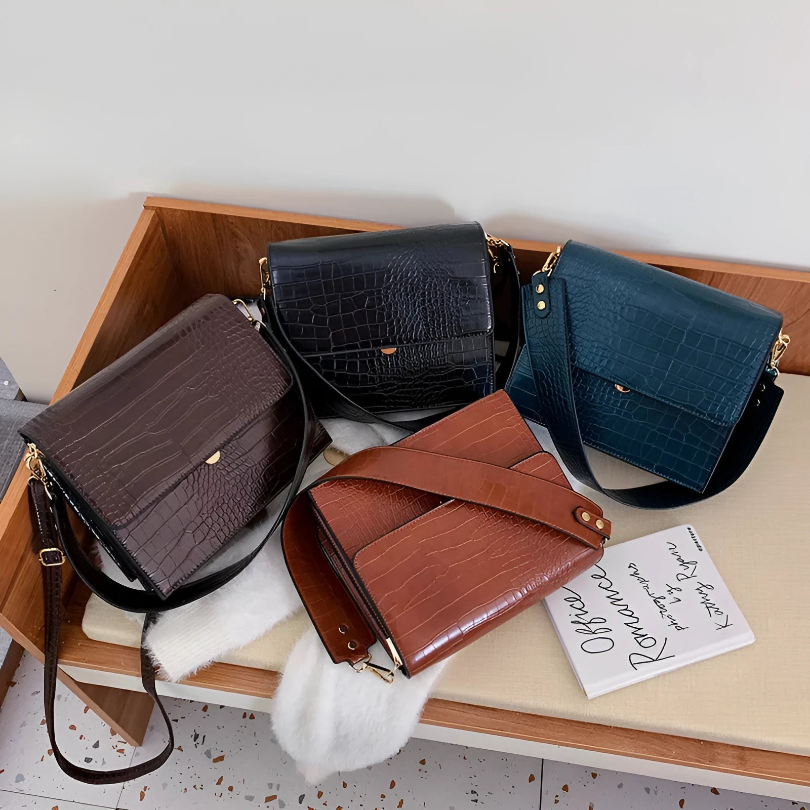 Stone pattern small square PU shoulder bag with flap closure and double straps, shown in blue, black, bronze, and yellow colour options