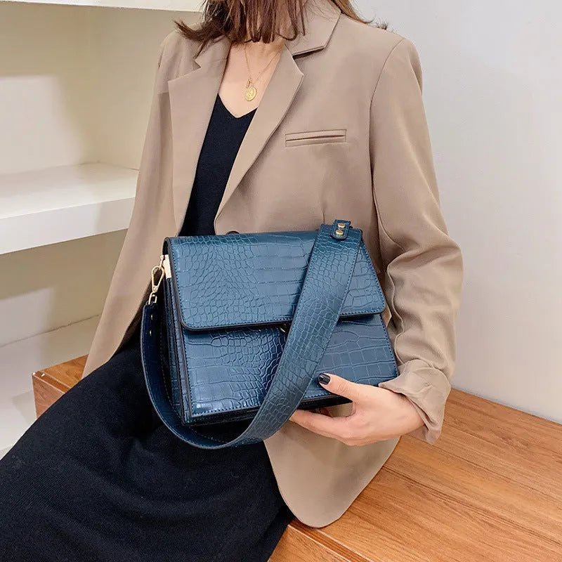 Stone pattern small square PU shoulder bag with flap closure and double straps, shown in blue, black, bronze, and yellow colour options