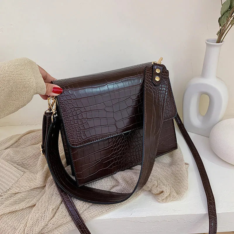 Stone pattern small square PU shoulder bag with flap closure and double straps, shown in blue, black, bronze, and yellow colour options