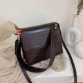 Stone pattern small square PU shoulder bag with flap closure and double straps, shown in blue, black, bronze, and yellow colour options