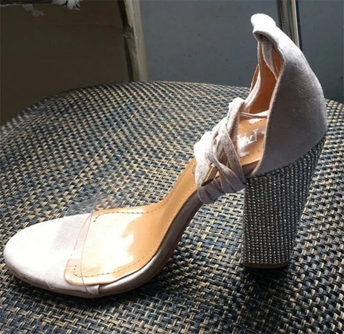 Black and gold plastic high heels with pointed toe and stiletto heel