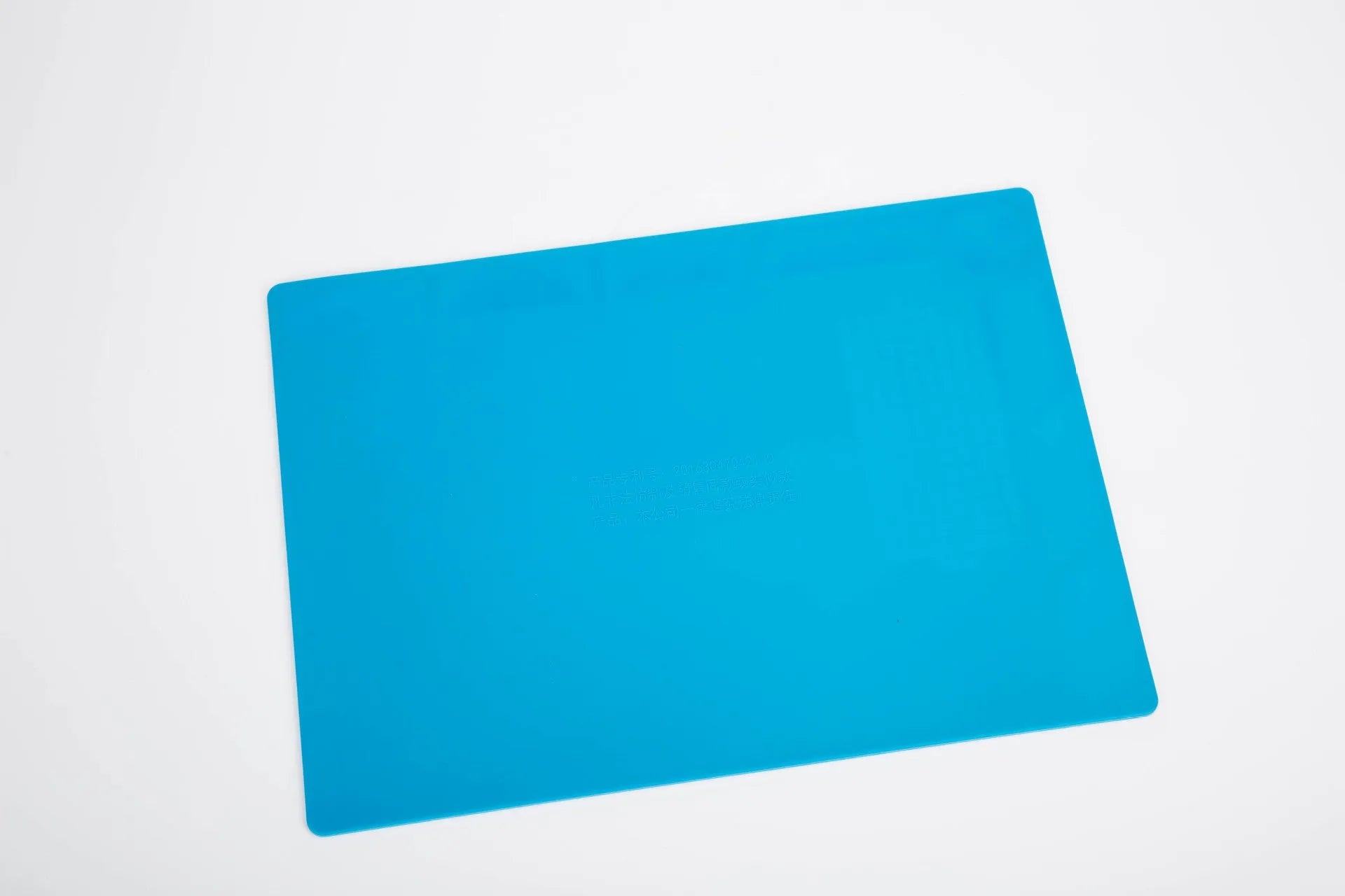 Blue silicone anti-skid watch repair mat on a workbench for horology tools.